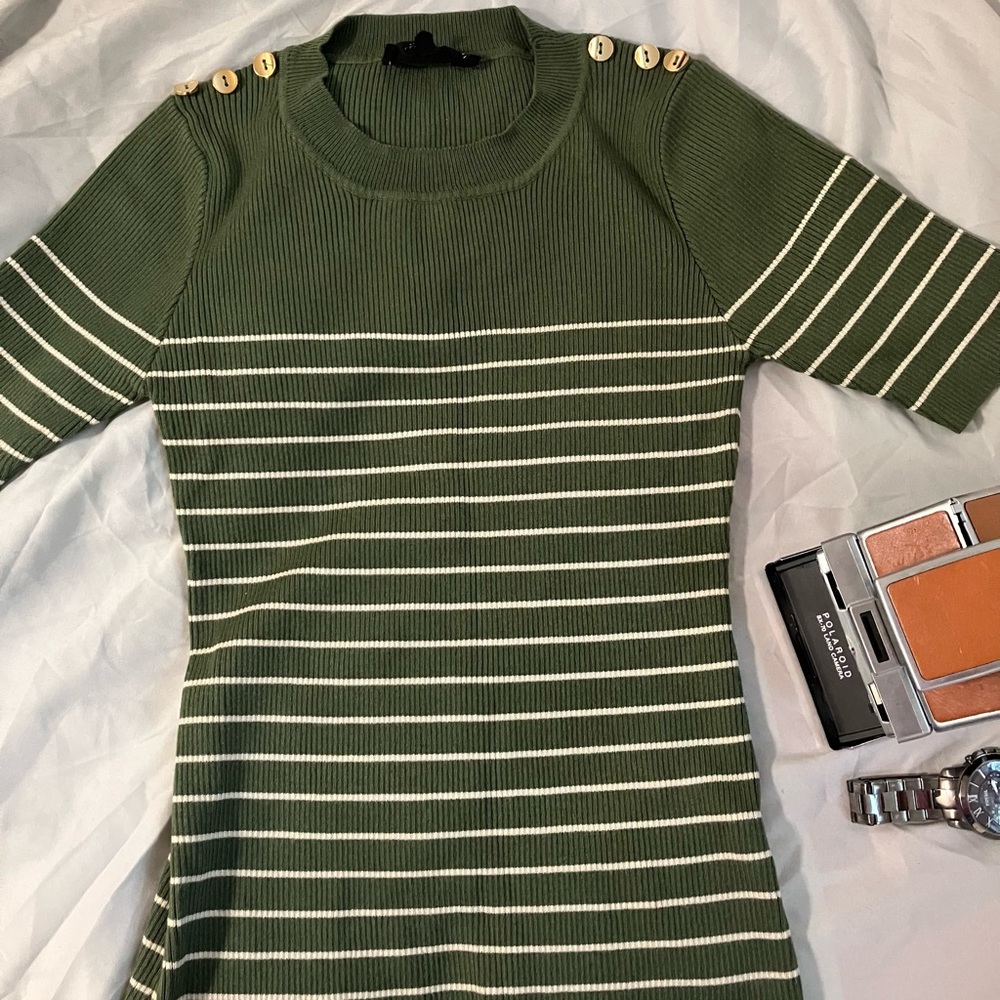 Olive green shirt and brand Sweet Wanderer. It’s in a size Medium in Women’s.